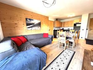 a living room with a couch and a table at Esprit chalet-Le Snoroc C36 in Aime La Plagne