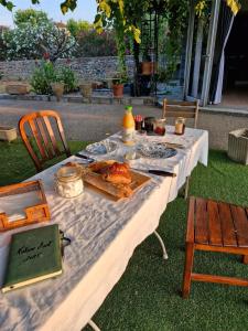 a white table with food on top of it at Chambres d'hôte - Nature d'Art in Ruoms