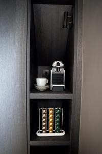 a cabinet with a shelf with a toaster and a radio at Meme Wiesje in Oudenburg +33 photos