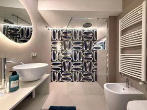 a bathroom with a sink and a shower curtain at Villa Emma Exclusive in Vico Equense