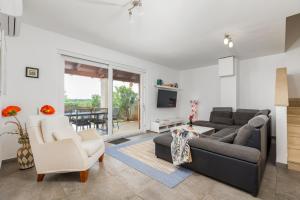 a living room with a couch and a table at Villa Katharina in Krmenjak