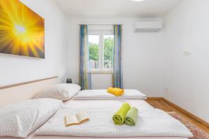 two twin beds in a room with a window at Villa Katharina in Krmenjak +49 photos