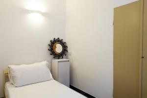 a bedroom with a bed and a mirror on the wall at Il Campanile by Wonderful Italy in Cotulo