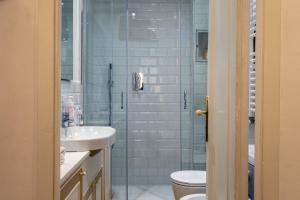 a bathroom with a shower and a sink and a toilet at Il Campanile by Wonderful Italy in Cotulo +9 photos