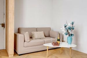 a living room with a couch and a table at 606 Aaron Suite - Apartment in Paris 7th in Paris