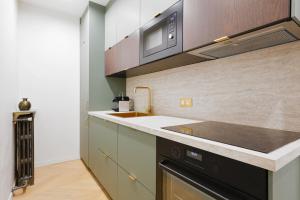 a kitchen with a sink and a microwave at 606 Aaron Suite - Apartment in Paris 7th in Paris +15 photos