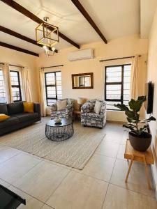 a living room with a couch and a table at The Exec Home Self Catering Villa in Gaborone