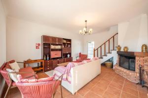 a living room with a couch and a fireplace at GuestReady - Fantastic family home in Sesimbra in Sesimbra