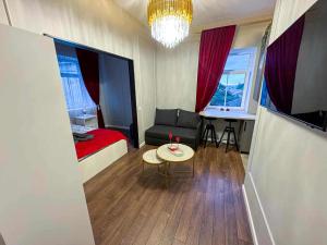 a small room with a bed and a couch and a table at Jacuzzi overlooking the tower in Vilnius