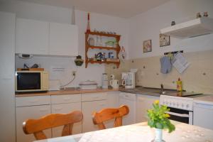 a kitchen with a table and two chairs in it at Ferienwohnung Seebauer in Ramspau
