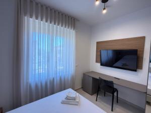 a room with a desk with a television and a chair at MONTELLA B&b in Gaeta