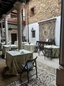 a room with tables and chairs in a building at Palacio Conde Toreno in Malleza +71 photos