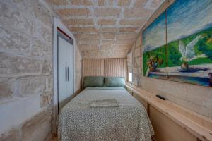 a bedroom with a bed and a painting on the wall at San Leonardo Apartments in Lecce