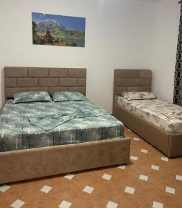 two beds sitting next to each other in a bedroom at Villa Sofia in Durrës