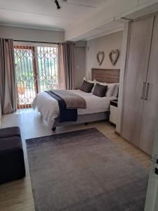 a bedroom with a large bed and a large window at 258 on Aries in Pretoria