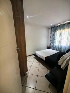 Habitación pequeña con cama y puerta en Tempo #03, en Vosburg