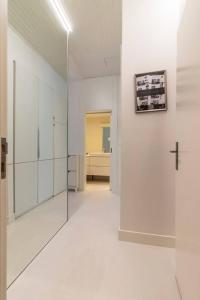 a hallway with white walls and a cross on a wall at Charming and Well-Located Studio in Chiado in Lisbon