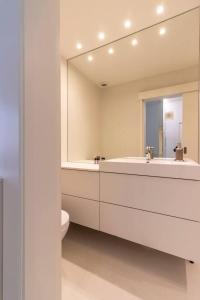 a bathroom with a tub and a toilet and a mirror at Charming and Well-Located Studio in Chiado in Lisbon
