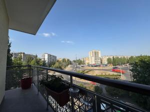 a balcony with two chairs and a view of a city at Pilot House in Mykolaiv
