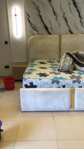 a bed in a room with a cross on the wall at Qelifox apartment service in Lekki