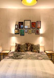 a bedroom with a bed with pictures on the wall at B&B Loft 57 in Amsterdam