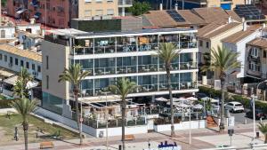 an aerial view of a building with palm trees at Meraki Beach Hotel - Only Adults in Playa Pobla de Farnals +38 photos