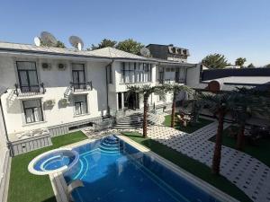 a large house with a swimming pool in the yard at National Gold Plaza in Samarkand