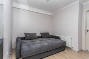 a large bed in a room with white walls at Starrent Testimiteanu Kaufland MallDova shopping mall in Chişinău