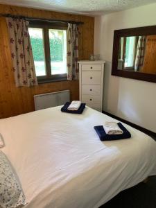 a bedroom with a large white bed with towels on it at Peaceful ground floor apartment in Saint-Gervais-les-Bains +14 photos