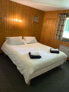 a bedroom with a bed with two towels on it at Peaceful ground floor apartment in Saint-Gervais-les-Bains