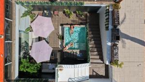 an overhead view of a patio with umbrellas and a swimming pool at Meraki Beach Hotel - Only Adults in Playa Pobla de Farnals