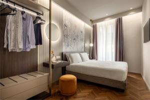 a small bedroom with a bed and a closet at Aramis Deluxe Rooms in Florence