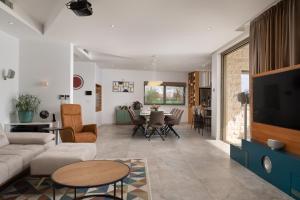 a living room with a couch and a table at Villa Olive Grove ZadarVillas in Smoković