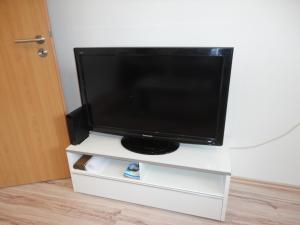 a flat screen tv sitting on a white entertainment center at Ferienwohnung Antel in Andernach