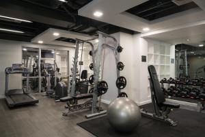 a gym with several tread machines and a ball at Astoria Plaza in Manila