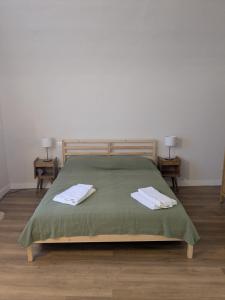 a bedroom with a bed with two towels on it at Casa del Viandante Romea del Chianti - Badia a Passignano in Badia A Passignano