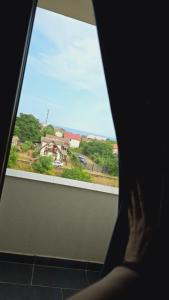 a person looking out of a window at the ocean at Damar in Costinesti