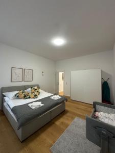 a bedroom with a large bed and a couch at Nook - Zentrale Lage - an der ListerMeile in Hannover