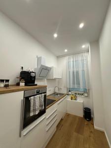 a kitchen with a sink and a stove top oven at Nook - Zentrale Lage - an der ListerMeile in Hannover +9 photos