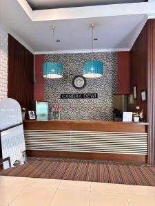 a restaurant with a counter and a clock on the wall at Candra Dewi Yogyakarta in Yogyakarta +28 photos