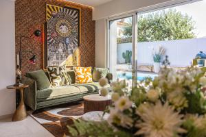 a living room with a couch and a window at Villa d'exception avec piscine, proche de la mer in Les Sables-dʼOlonne