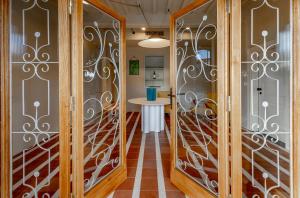 a hallway with wrought iron doors and a table at Cantina Semonte Wine Resort in Gubbio