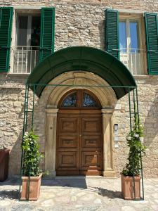 a wooden door in front of a building at Cantina Semonte Wine Resort in Gubbio
