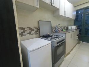 a kitchen with a stove and a white stove top oven at Executive 1 bedroom house in Nairobi
