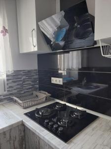 a kitchen with a stove top oven in a kitchen at Nataliia Apartment in Perea