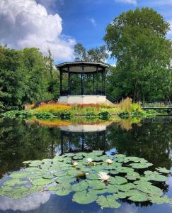 a pond with a gazebo in a park at B&B Loft 57 in Amsterdam