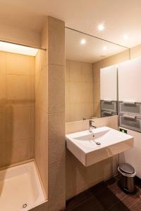 a bathroom with a sink and a bath tub at Well-Located Studio with Smart Space in Lisbon