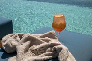 a glass of wine sitting on a towel next to a pool at Este Elegant Suites & Villas - Adults Only in Kiotari