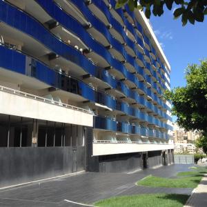 an external view of a building with blue balconies at Benidorm La Cala Sidney in Cala de Finestrat