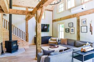 a living room with a couch and a stove at Lux Chalet 4 Bd Fireplace HotTub AC Pet Friendly in Killington